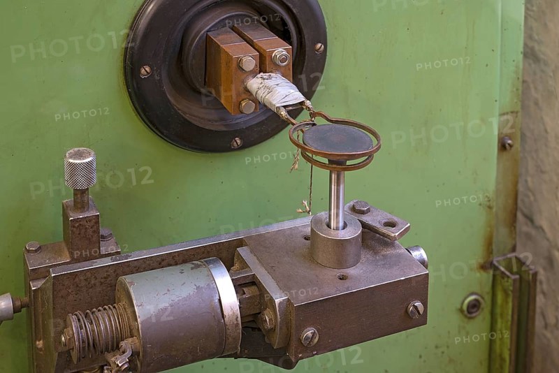 Copper coil of an induction hardening machine in a historical valve factory