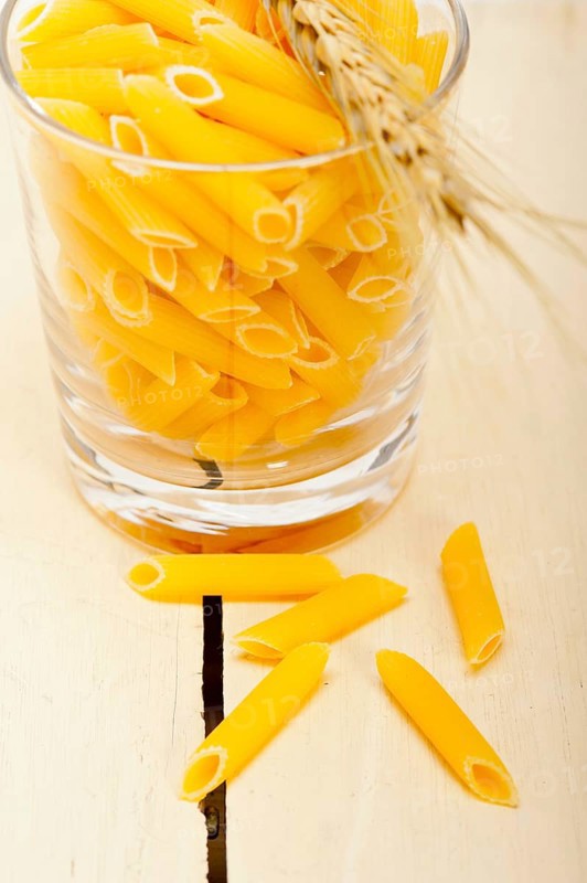 Short Italian pasta penne with durum wheat grains