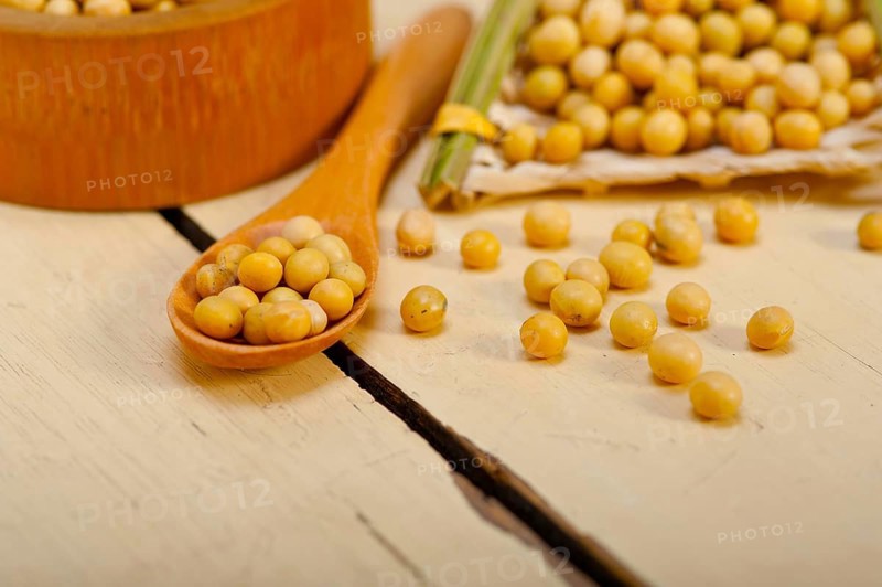 Organic soya beans over rustic wood table macro closeup