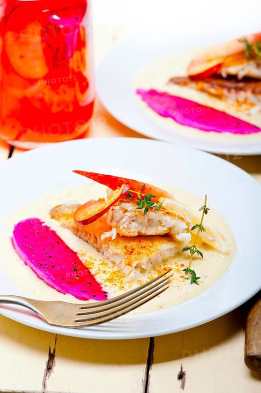 Sea bream orata fillet butter pan fried with fresh peach prune and dragonfruit slices thyme on top