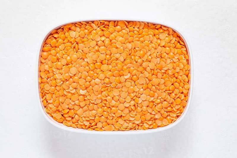 The red split lentil also known as Egyptian lentil or Masoor dal against white background