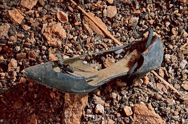Black women's shoe with heel and bow at the bottom