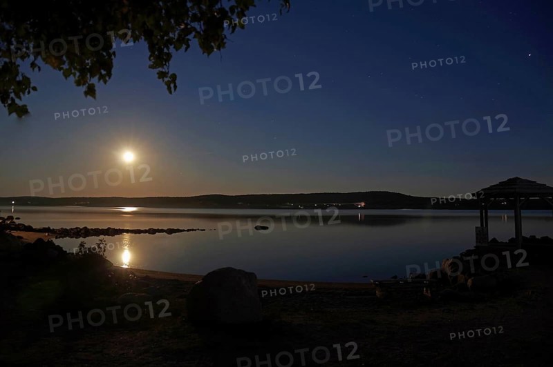 Full moon over a body of water