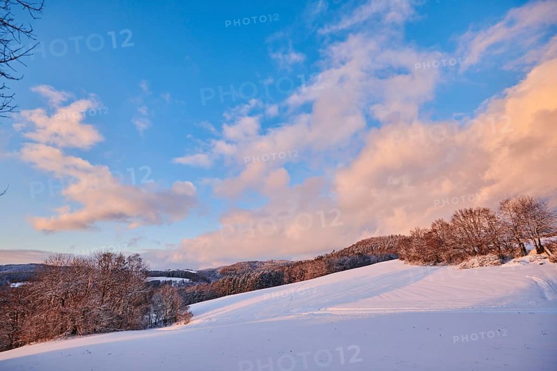 Colored Clouds over a field covered with snow near Wiesent