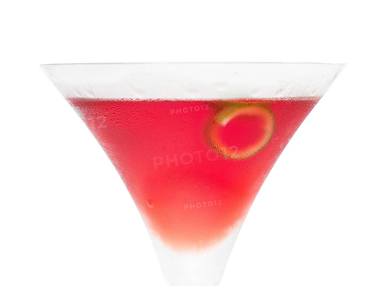 Cosmopolitan drink cocktail straight up on martini cup with lime peel isolated on white background