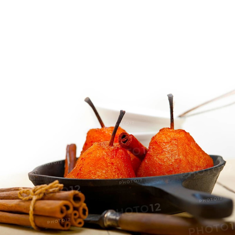 Poached pears delicious home made recipe ove white rustic wood table