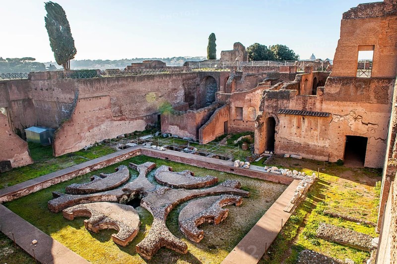 Ruin remains of ancient Pelta fountain in sunken peristyle former portico in former imperial palace Domus Augustana