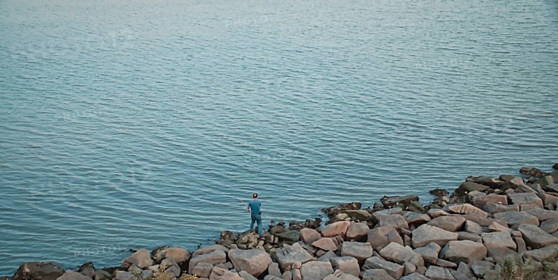A man fishing by the sea