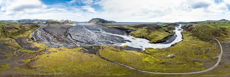 River with fanned out branches through black lava sand