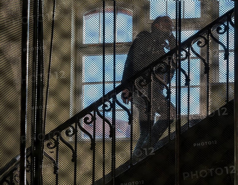 View through the bars of an old lift in an old factory