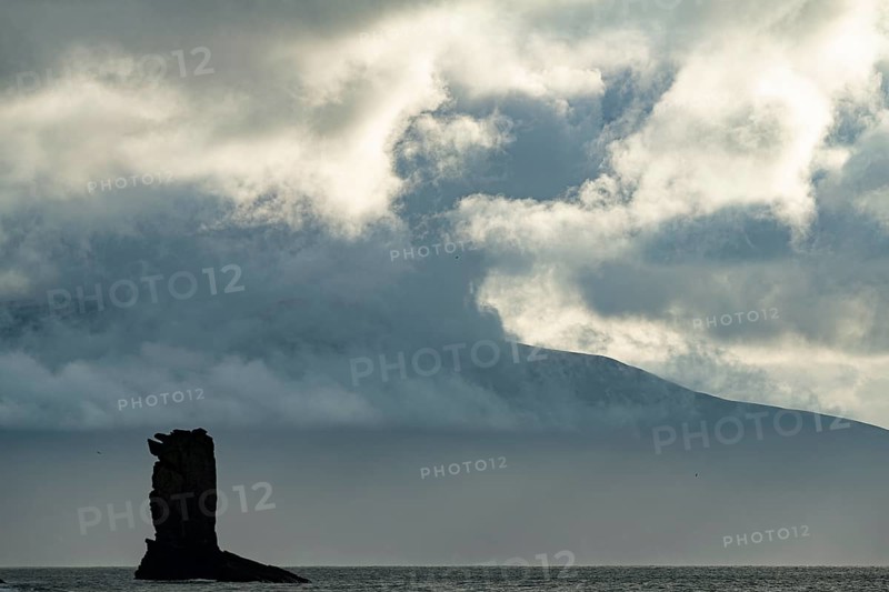 North Atlantic with rock needle and cloudy sky