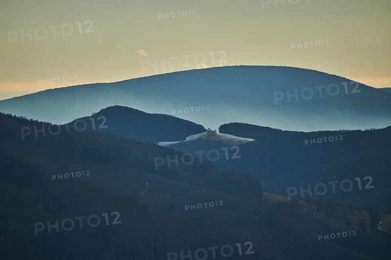 Fog lying in a valley in between to hills