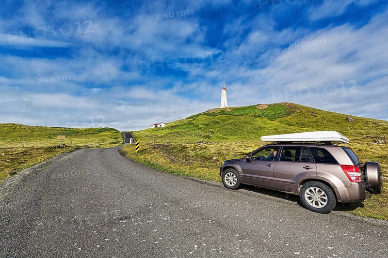 Tourist in an off-road vehicle with roof tent at the roadside
