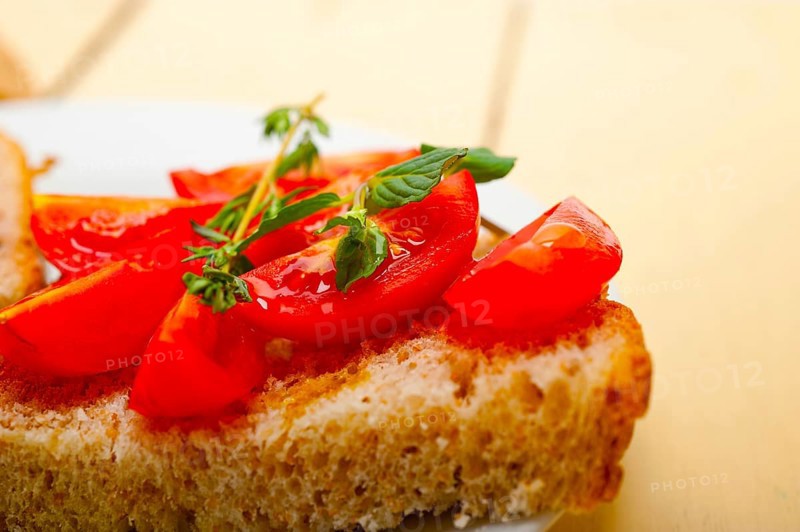 Italian tomato bruschetta with thyme and mint leaves
