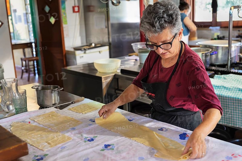 Preparing a lasagne in the kitchen of an agriturismo