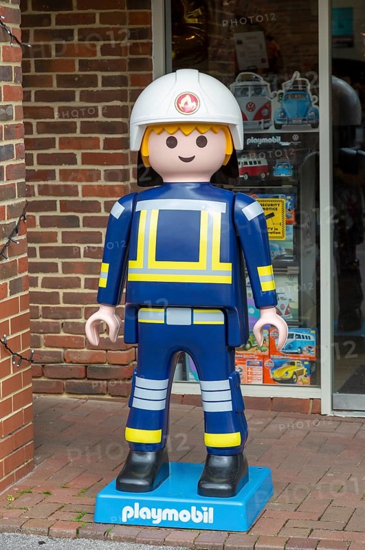 Giant Playmobil character model outside toy shop