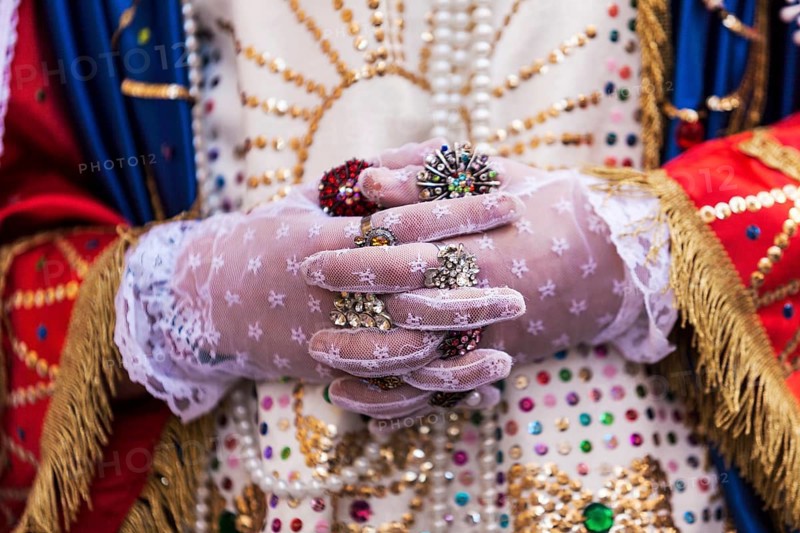 Detail of gloved hands and unique attire of the Veroniche during the Holy Thursday procession in Marsala