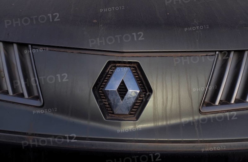 Renault car logo on dirty front panel with radiator grille