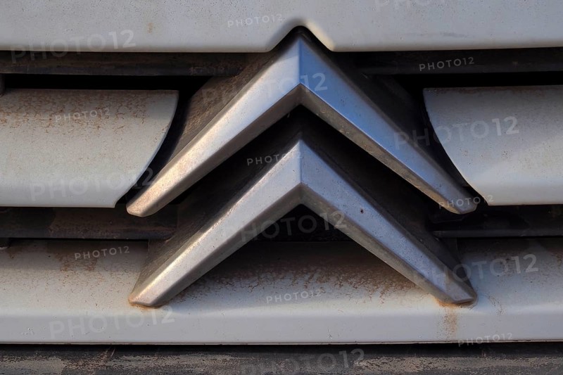 Citroeen car logo on dirty radiator grille