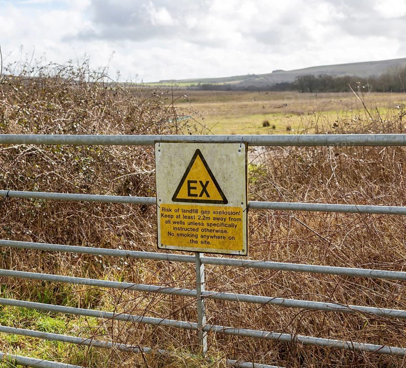 Sign warning of danger of gas explosion at landfill site