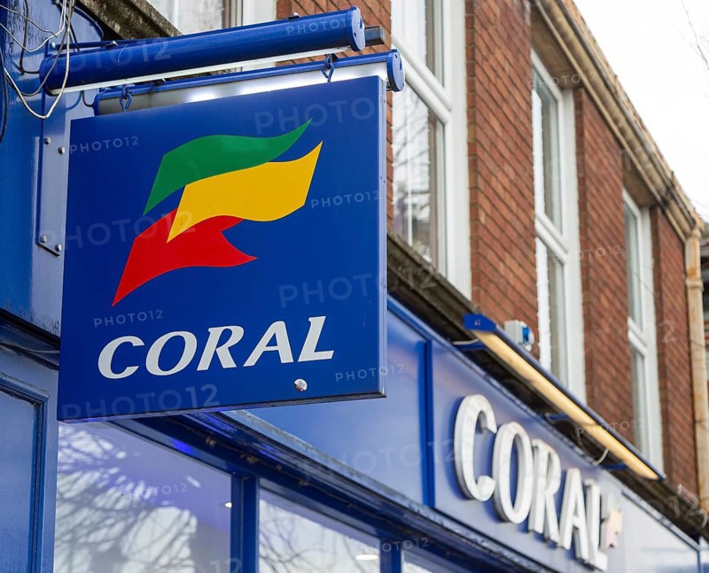 Wall mounted sign outside Coral bookmakers shop