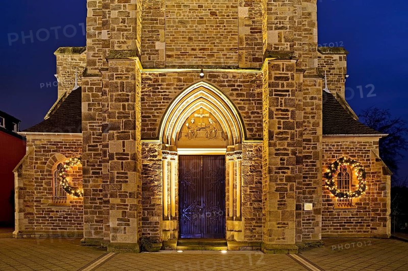 Illuminated entrance to the parish church of St. Suitbertus