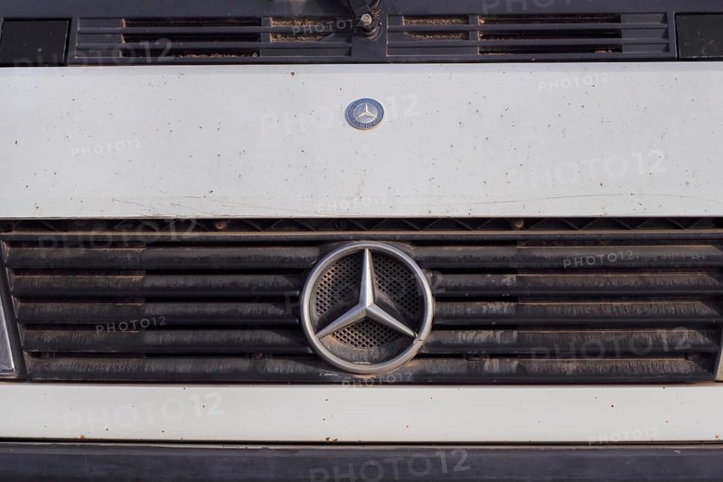 Mercedes car logo on dirty radiator grille