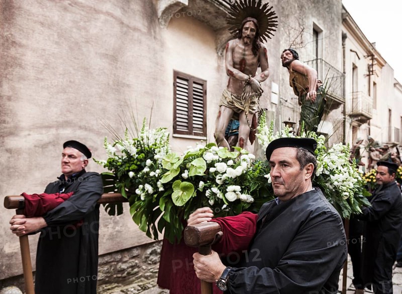 Men taking a rest during the Good Friday processions in the streets of Erice