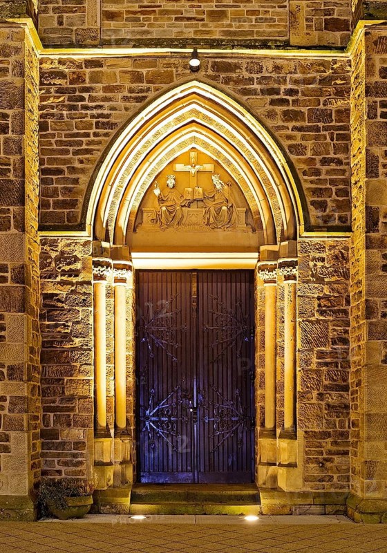 Illuminated entrance to the parish church of St. Suitbertus