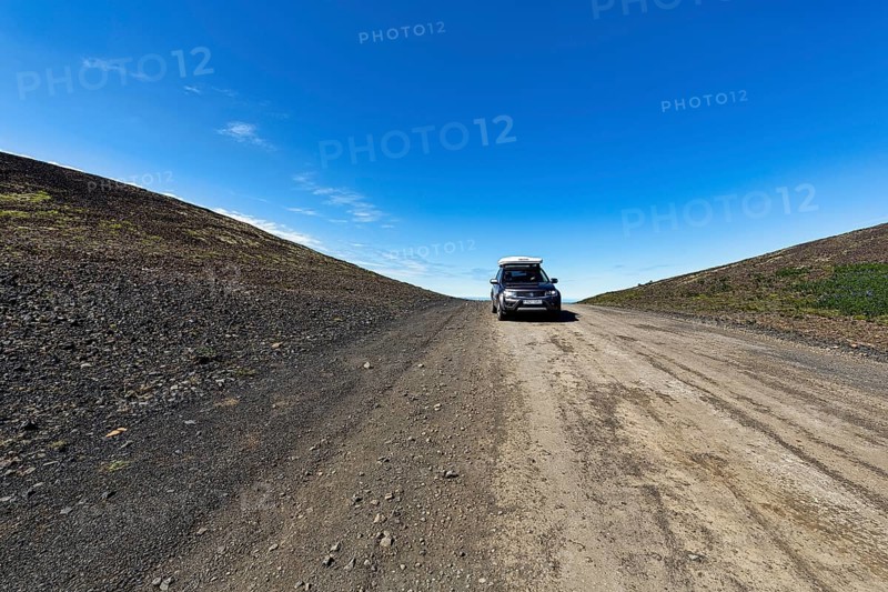 Off-road vehicle with roof tent in summer