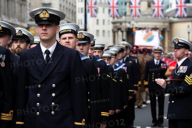 British navy participants enjoy the London Pride festival in brilliant sunshine under Union Jacks. London