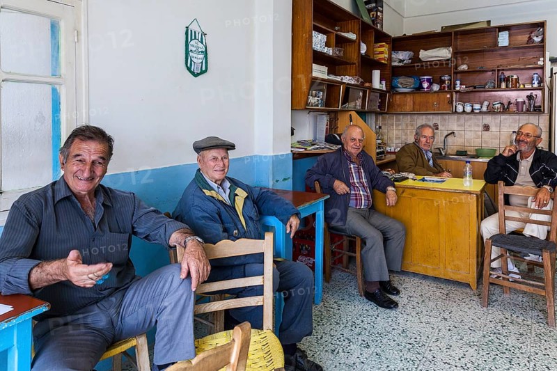 Elderly Greek men sitting in an improvised bar in the town of Kos