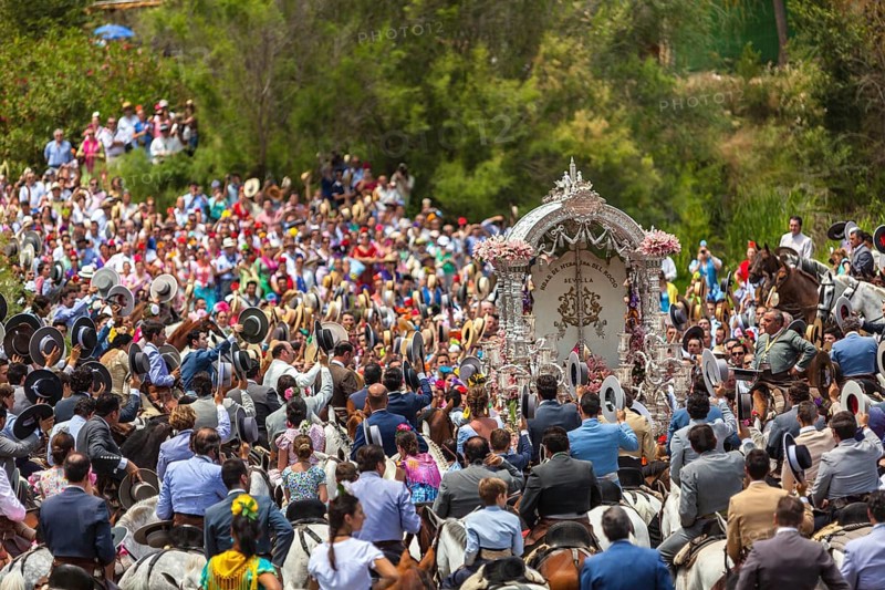 Procession with many people crossing of the river Guadalguivir