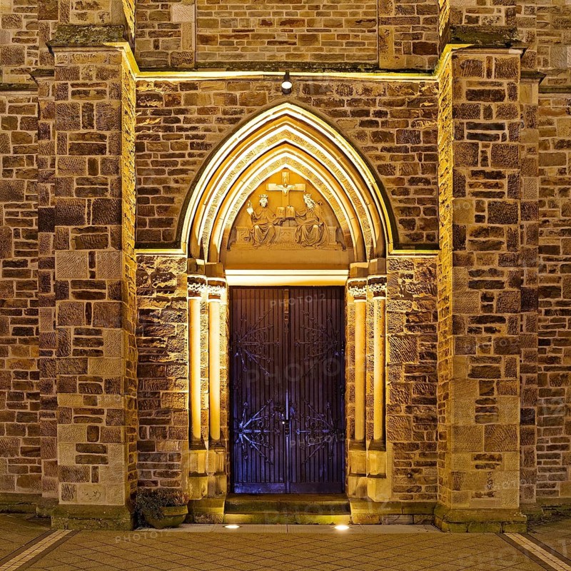Illuminated entrance to the parish church of St. Suitbertus