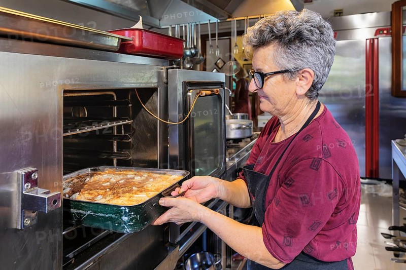 Preparing a lasagne in the kitchen of an agriturismo