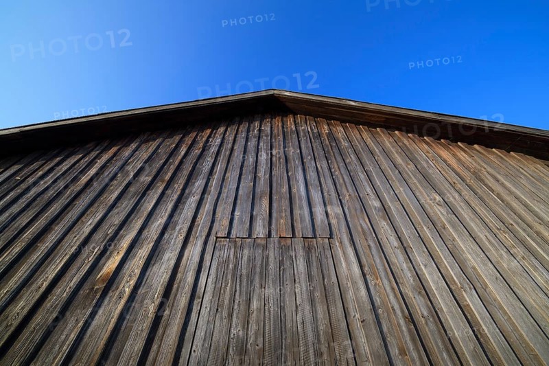 Wooden wall of a barn with sky