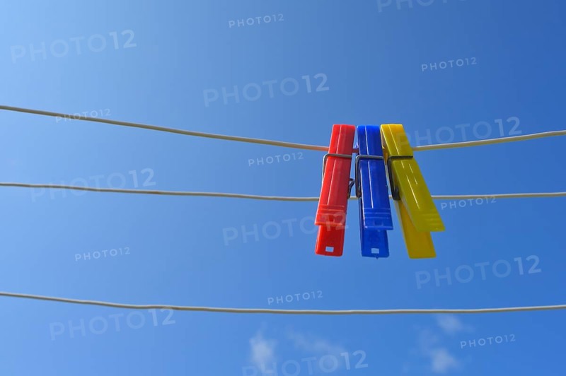 Clothesline with clothespins against blue sky