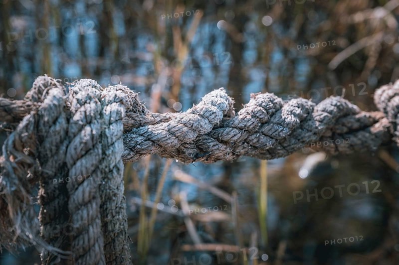 An old grey jute rope exposed to the weather