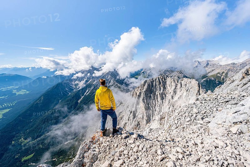 Hiker at the west summit of Hohe Munde