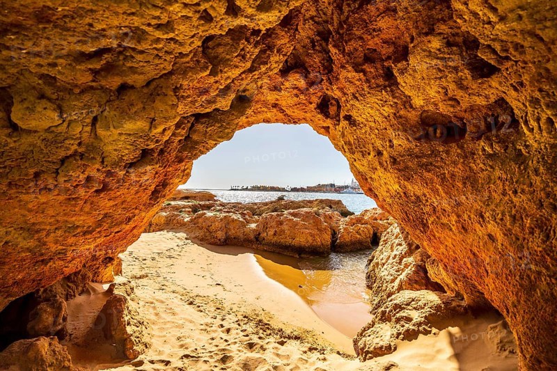 Beautiful sandstone arch with the view on marina in Portimao