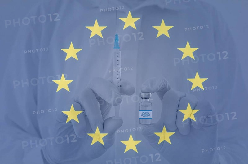Doctor hands holding a vaccine bottle and syringe
