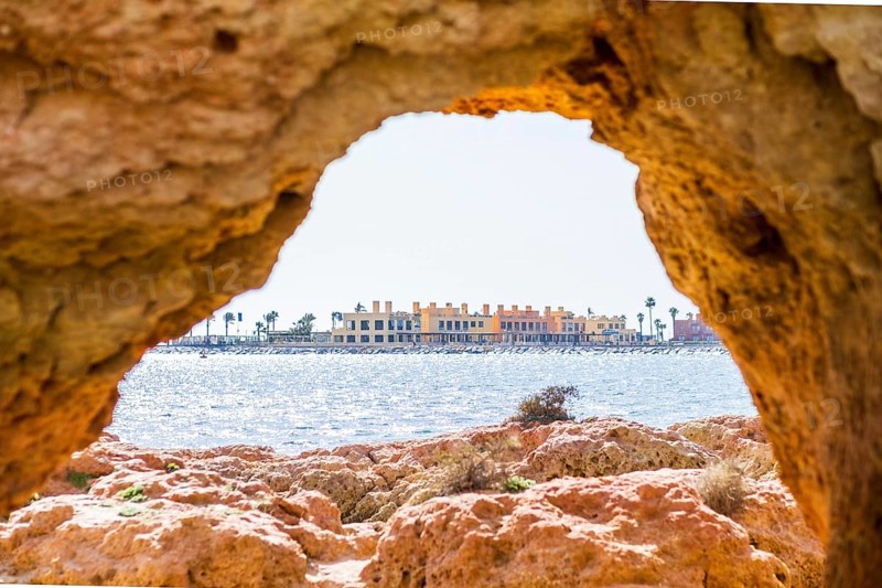 Beautiful sandstone arch with the view from Ferragudo to marina in Portimao