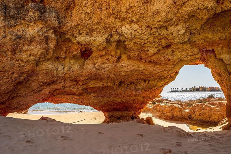 Beautiful sandstone arch with the view on marina in Portimao