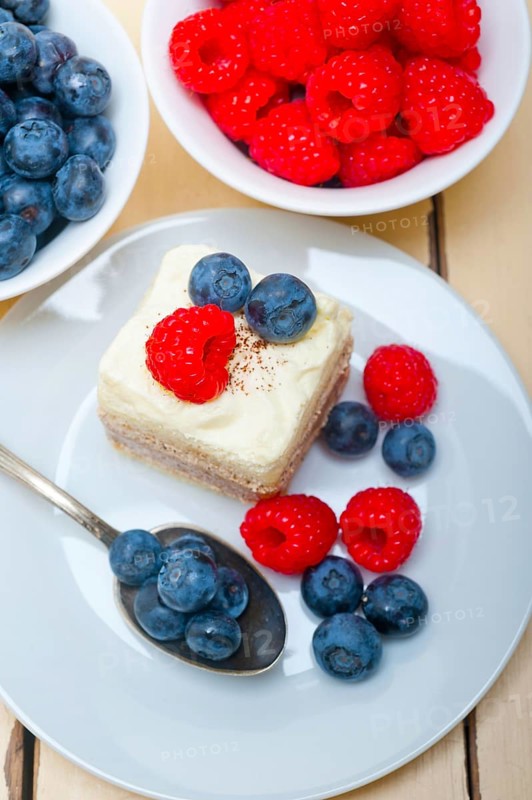Fresh homemade raspberry and blueberry cream cake