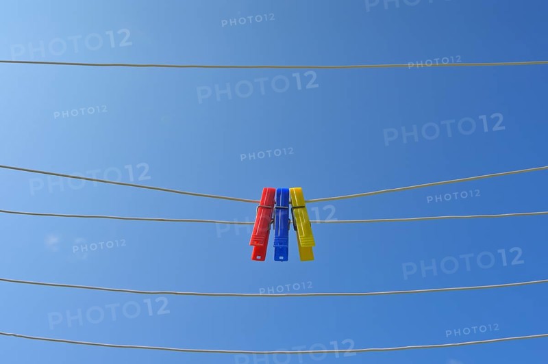 Clothesline with clothespins against blue sky