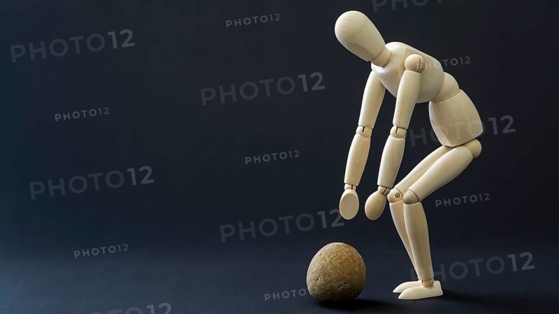 The mannequin is picking up the stone