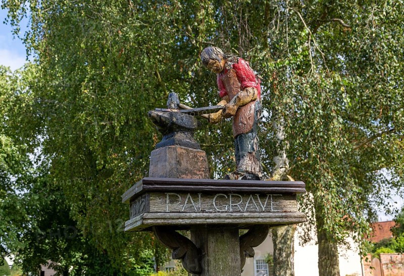 Model of blacksmith working on village sign for Palgrave