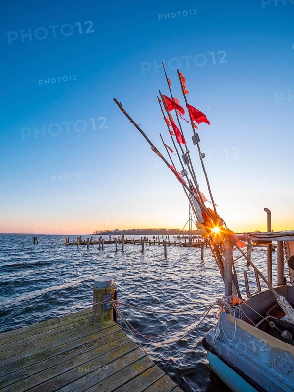 Fishing cutter in the harbour at the Salzhaff at sunset
