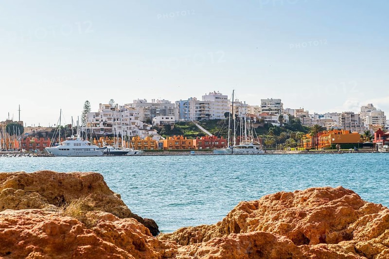 Marina in Portimao view through beautiful sandstone rocks in Ferragudo