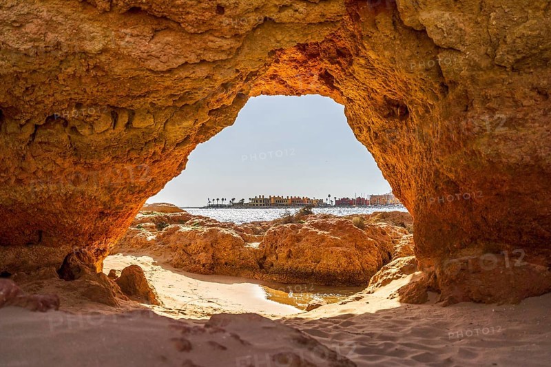 Beautiful sandstone arch with the view on marina in Portimao